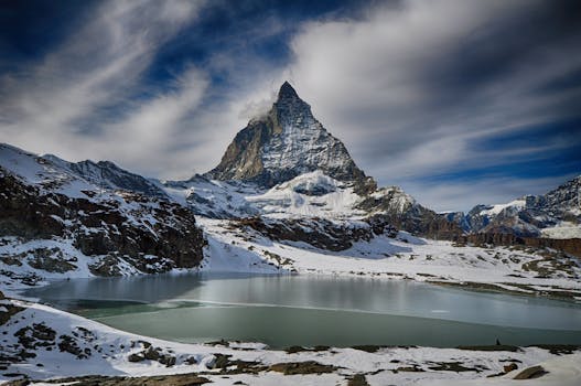 Scenic winter view of the Matterhorn mountain with a lake, perfect for adventure and travel imagery.