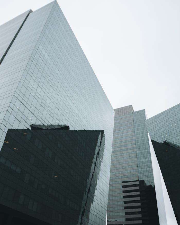 Low angle view of modern skyscrapers in São Paulo, showcasing urban architecture and reflections.